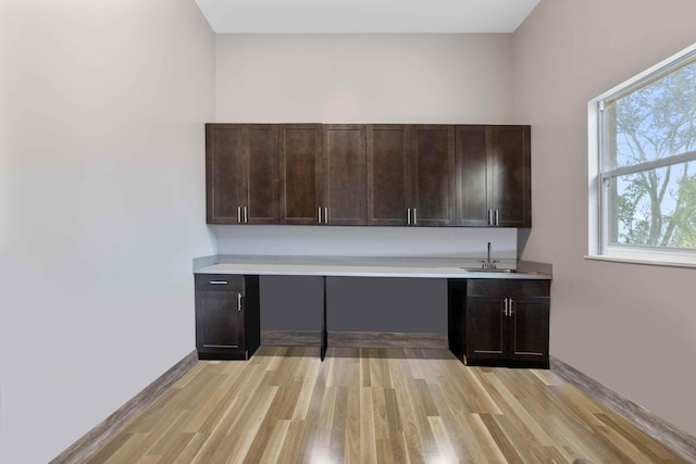 unfurnished office featuring light hardwood / wood-style floors and sink