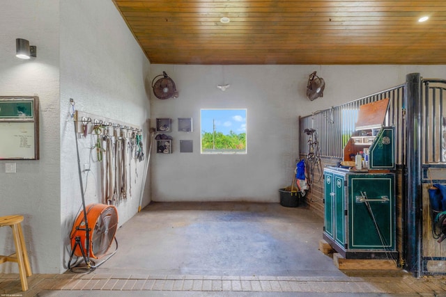 misc room featuring wooden ceiling and concrete floors