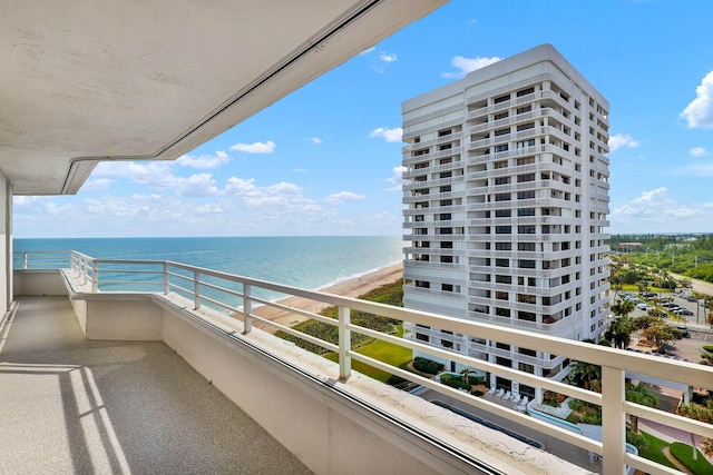 balcony featuring a water view and a view of the beach