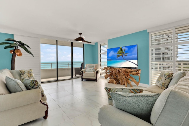 living room with ceiling fan and floor to ceiling windows