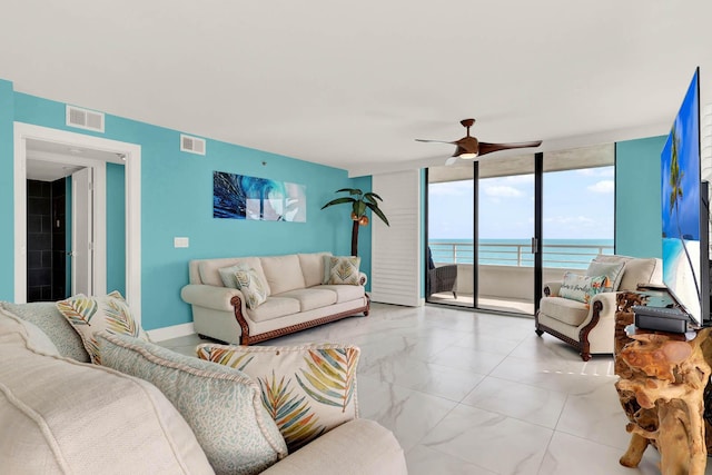 living room with floor to ceiling windows and ceiling fan