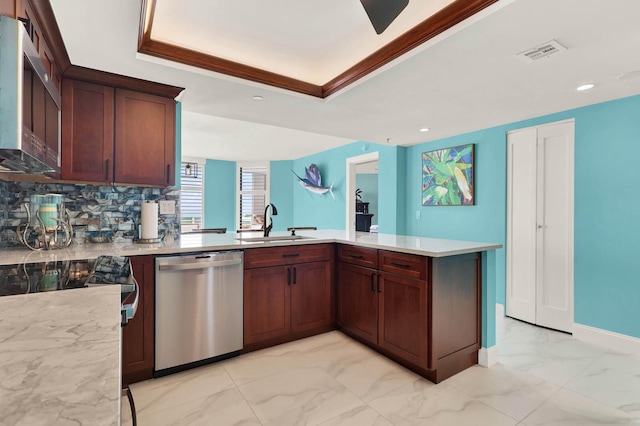 kitchen with appliances with stainless steel finishes, sink, backsplash, kitchen peninsula, and a raised ceiling