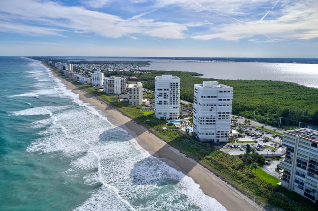 bird's eye view featuring a water view and a beach view