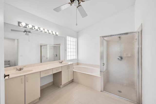 full bathroom with toilet, vaulted ceiling, vanity, independent shower and bath, and ceiling fan