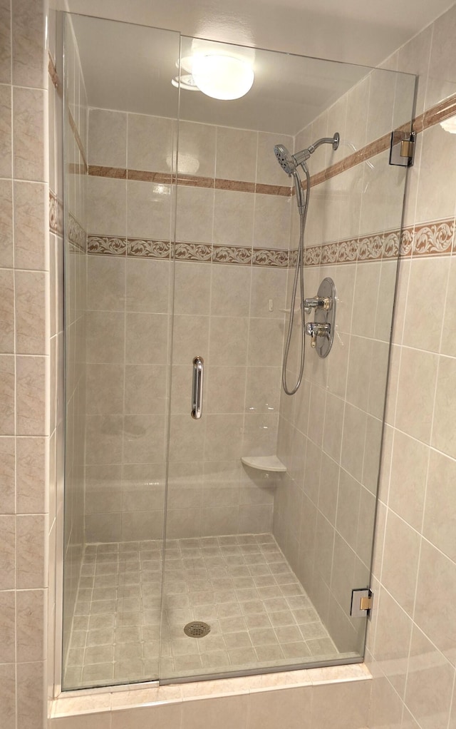 bathroom with a shower with door