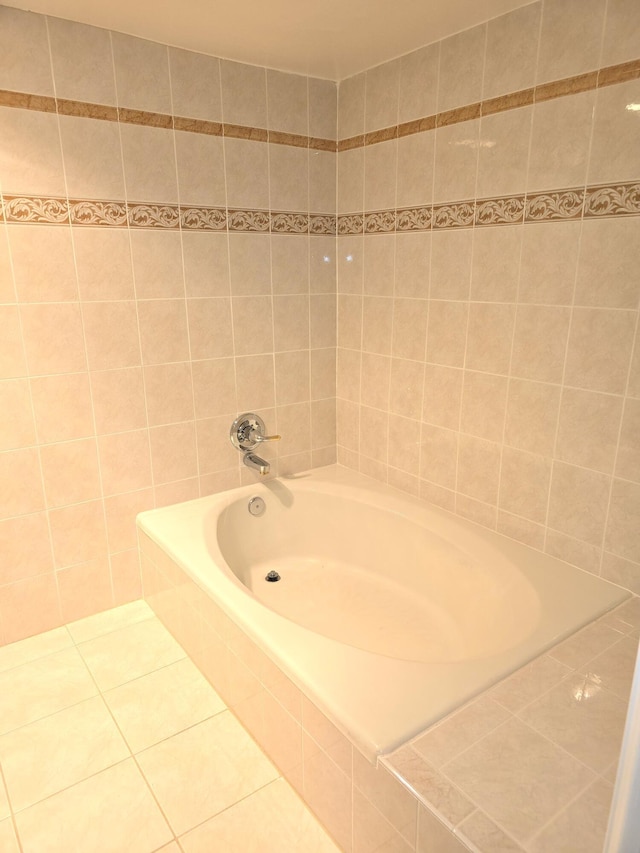 bathroom featuring a relaxing tiled tub and tile patterned floors