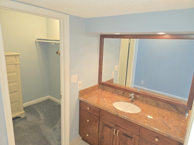 bathroom with vanity and a textured ceiling