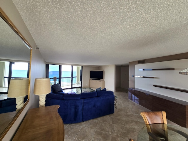 tiled living room with a wealth of natural light and a textured ceiling