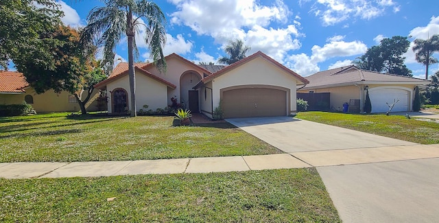 view of front of property featuring a garage and a front yard