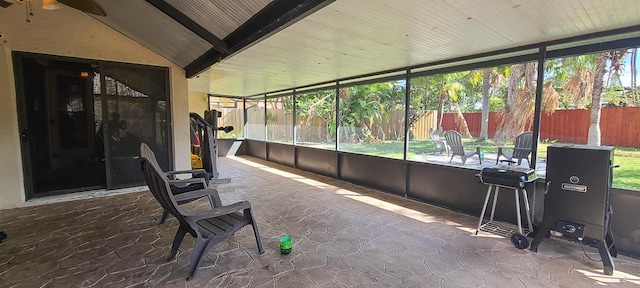 unfurnished sunroom with lofted ceiling with beams