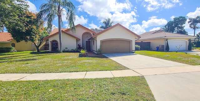 mediterranean / spanish-style home featuring a garage and a front lawn