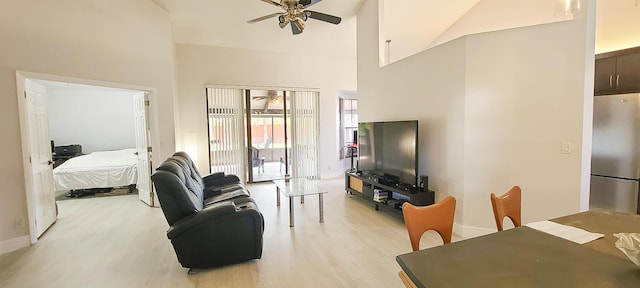 living room with high vaulted ceiling, ceiling fan, and light hardwood / wood-style floors