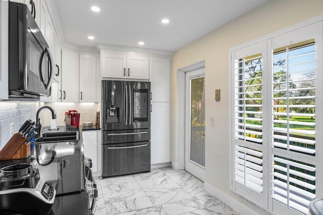 kitchen with sink, decorative backsplash, black appliances, and white cabinets