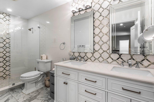 bathroom with vanity, a tile shower, backsplash, and toilet