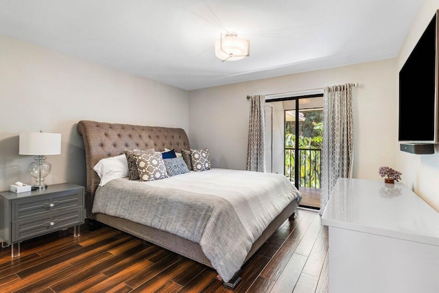 bedroom with access to exterior and dark wood-type flooring