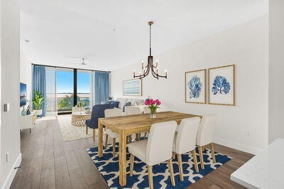 dining space featuring dark wood-type flooring, floor to ceiling windows, and a notable chandelier