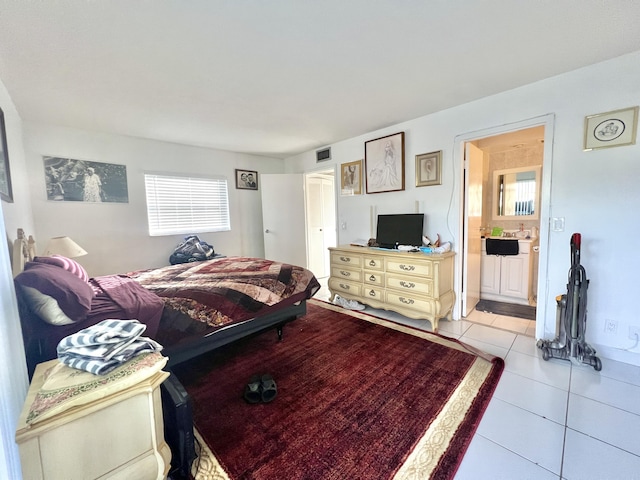 tiled bedroom featuring ensuite bathroom