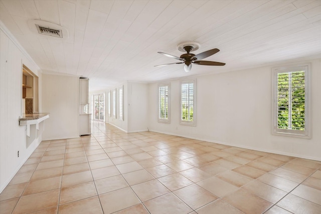 tiled spare room with ceiling fan and a healthy amount of sunlight