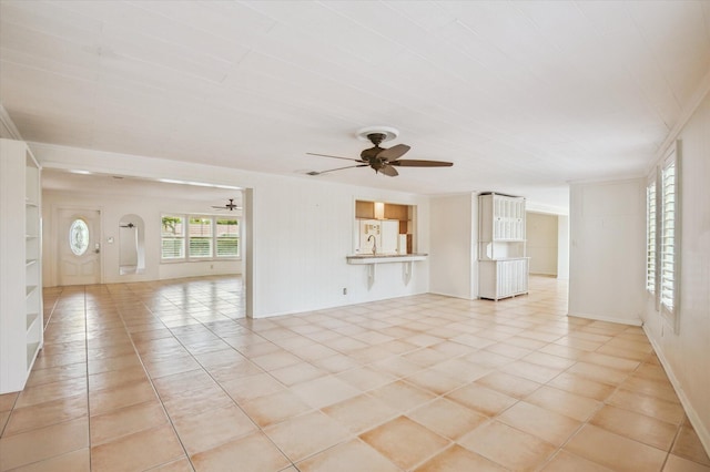 unfurnished living room featuring ceiling fan and light tile patterned flooring