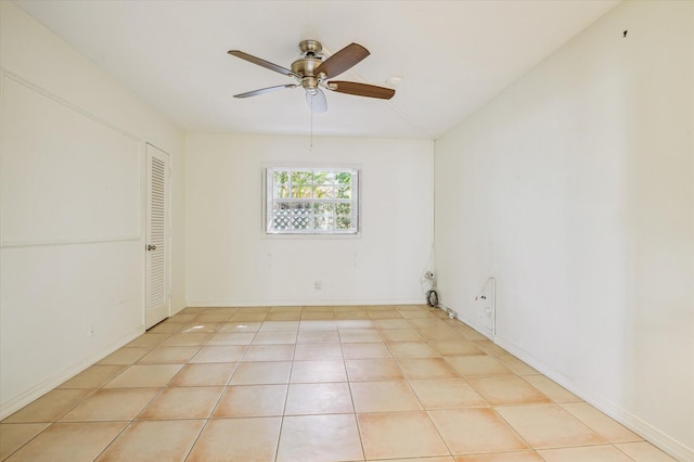 spare room with light tile patterned floors and ceiling fan