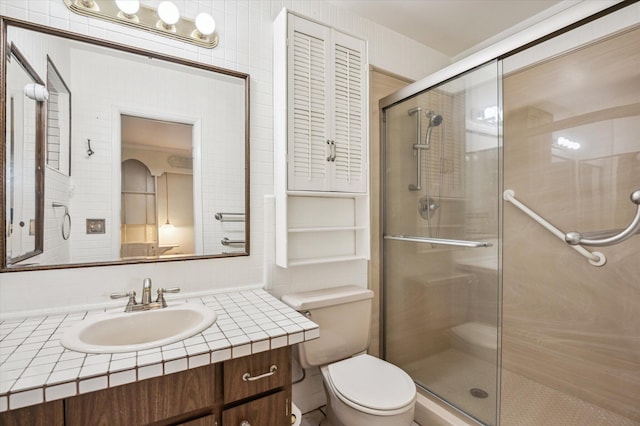 bathroom featuring decorative backsplash, walk in shower, vanity, and toilet