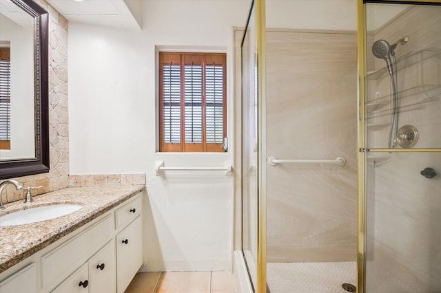 bathroom featuring an enclosed shower, vanity, and tile patterned floors