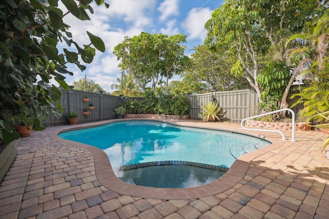 view of swimming pool featuring an in ground hot tub and a patio