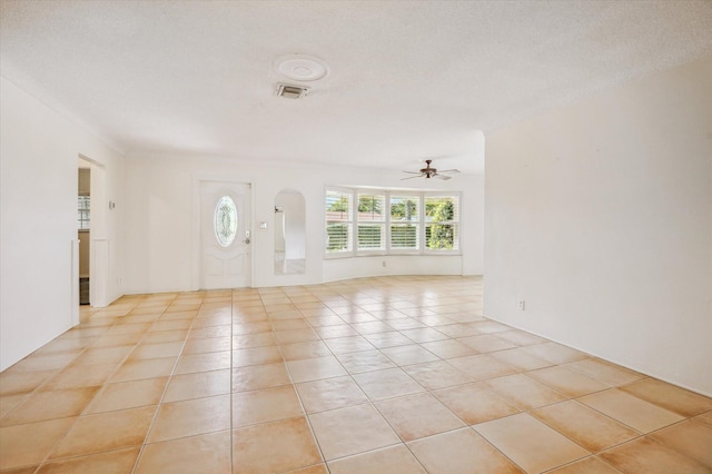 foyer entrance featuring light tile patterned flooring, a textured ceiling, and ceiling fan