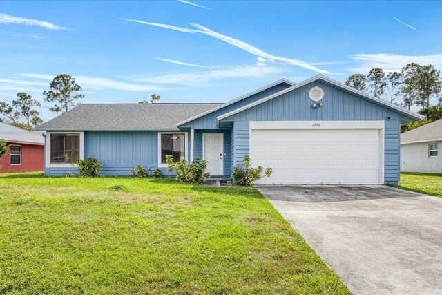 ranch-style home featuring a garage and a front yard