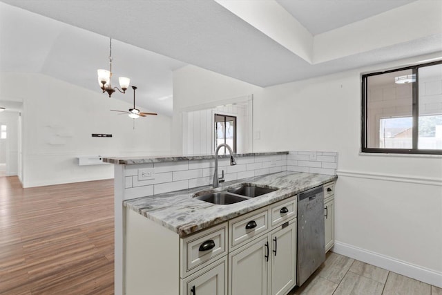 kitchen with sink, light hardwood / wood-style flooring, dishwasher, kitchen peninsula, and light stone countertops