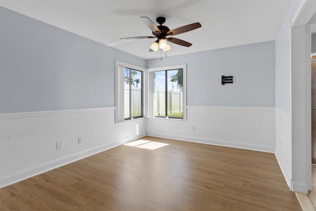 unfurnished room featuring ceiling fan and hardwood / wood-style floors