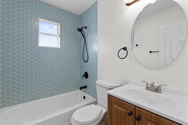 full bathroom with vanity, tiled shower / bath combo, and toilet