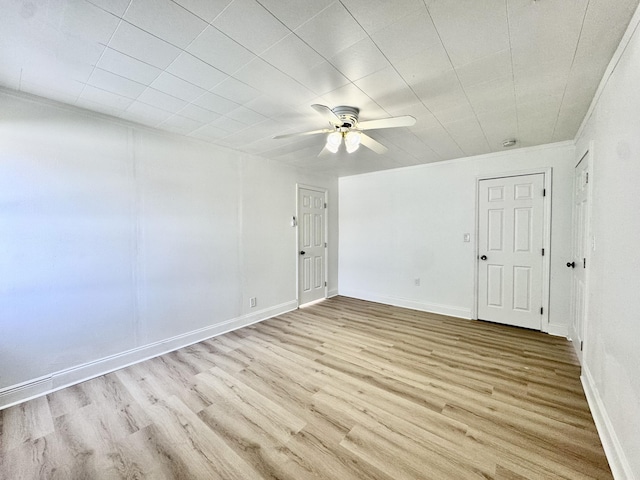 spare room featuring ceiling fan, ornamental molding, and light hardwood / wood-style floors