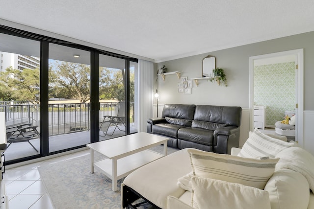 tiled living room with expansive windows and a textured ceiling