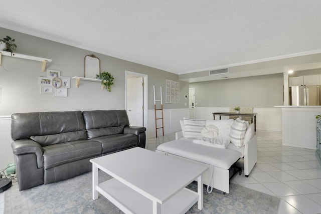 tiled living room featuring a textured ceiling