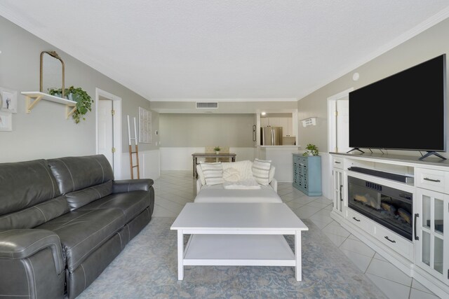 kitchen with sink, stainless steel appliances, light stone counters, white cabinets, and light tile patterned flooring