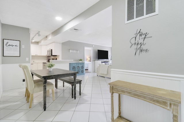 dining area featuring light tile patterned floors and track lighting