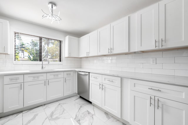 kitchen featuring sink, white cabinetry, stainless steel dishwasher, light stone countertops, and decorative backsplash