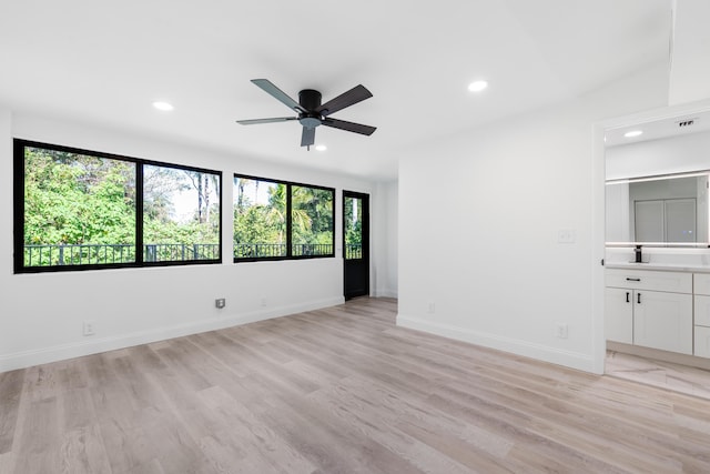 unfurnished room with ceiling fan and light wood-type flooring