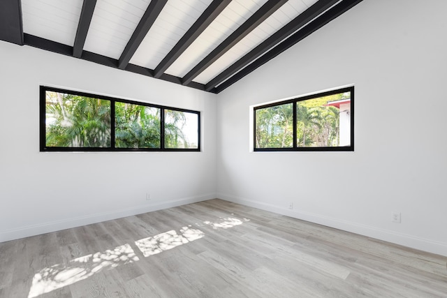 empty room with lofted ceiling with beams and light wood-type flooring