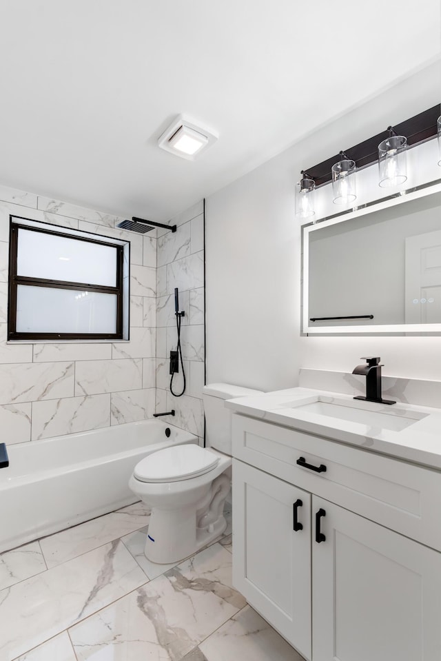 full bathroom with tiled shower / bath, vanity, and toilet