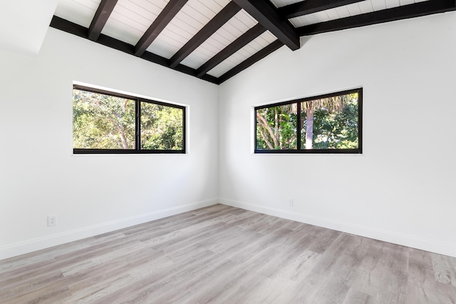 unfurnished room with light hardwood / wood-style flooring and lofted ceiling with beams