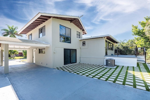 rear view of property featuring central AC unit