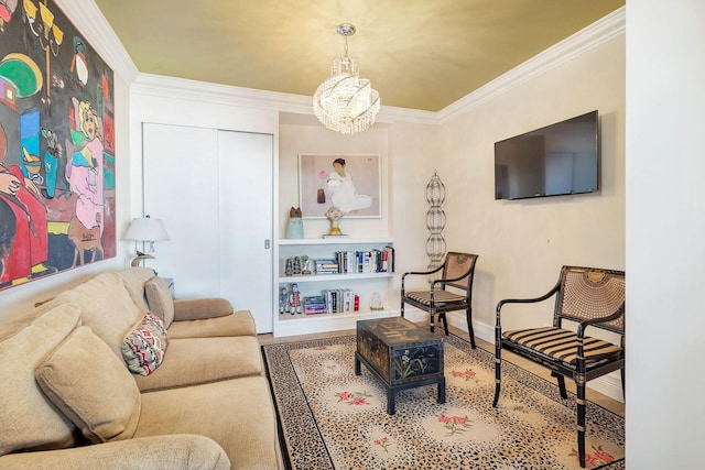 living room featuring crown molding, a chandelier, and hardwood / wood-style floors