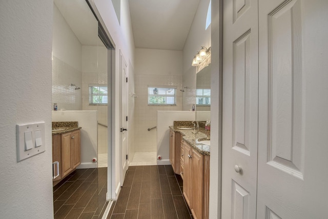 full bath with vanity, walk in shower, and wood tiled floors