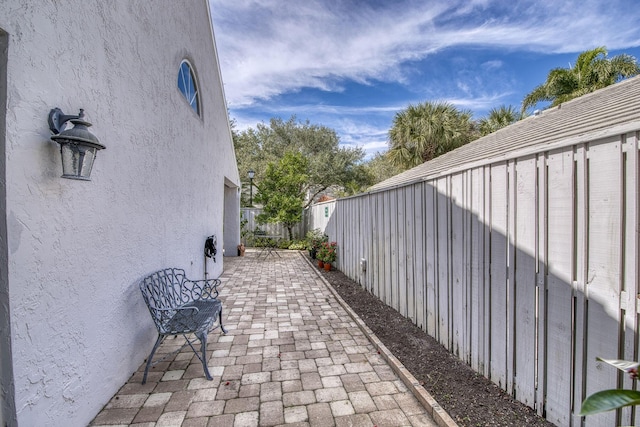 view of side of property featuring a patio area