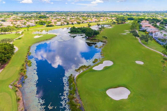 aerial perspective of suburban area featuring a nearby body of water and a local golf course