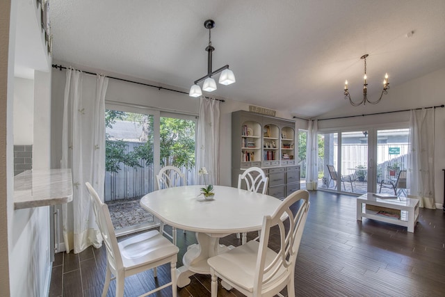 dining room with healthy amount of natural light, dark wood finished floors, and a chandelier