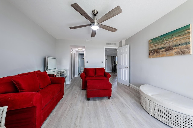 living room featuring light hardwood / wood-style floors and ceiling fan