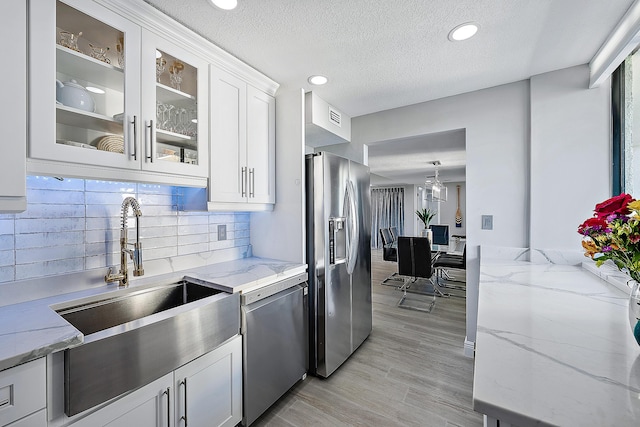 kitchen featuring light stone countertops, white cabinets, and appliances with stainless steel finishes